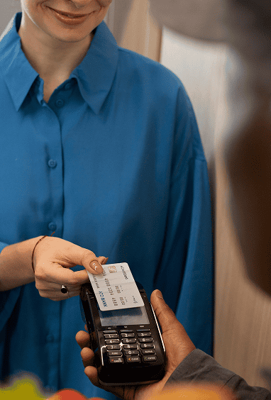 Woman paying for groceries at a checkout terminal