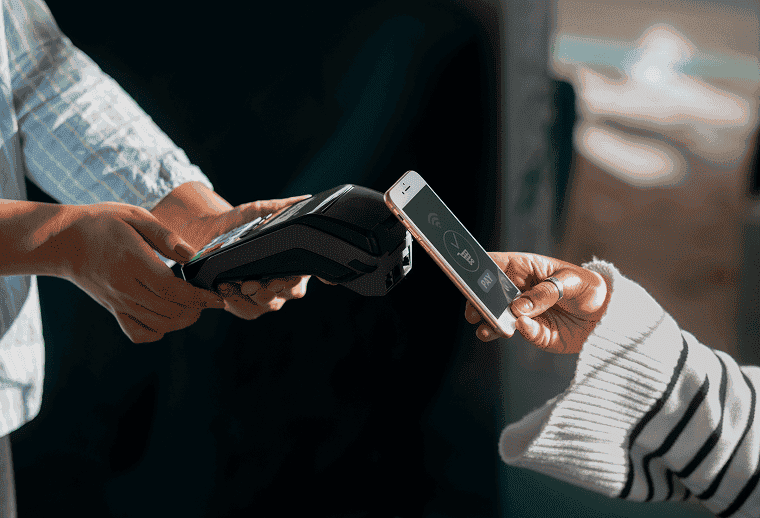 Diner paying by phone at a restaurant counter